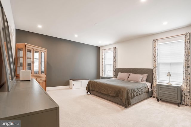 bedroom featuring light colored carpet