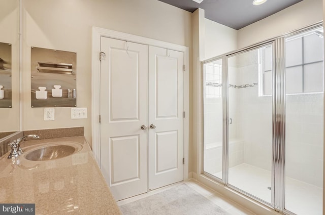 bathroom with vanity, tile patterned floors, and walk in shower