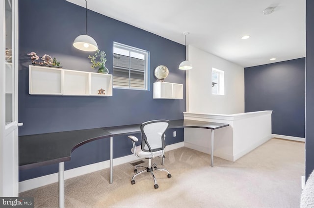 office area featuring light colored carpet and built in desk