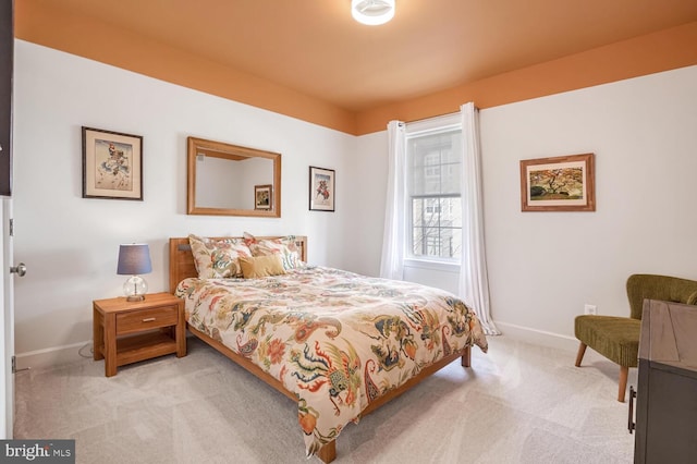 bedroom featuring light carpet