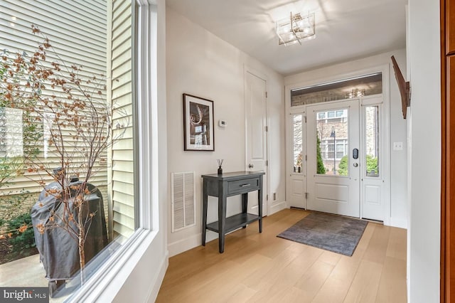 foyer entrance with light hardwood / wood-style flooring