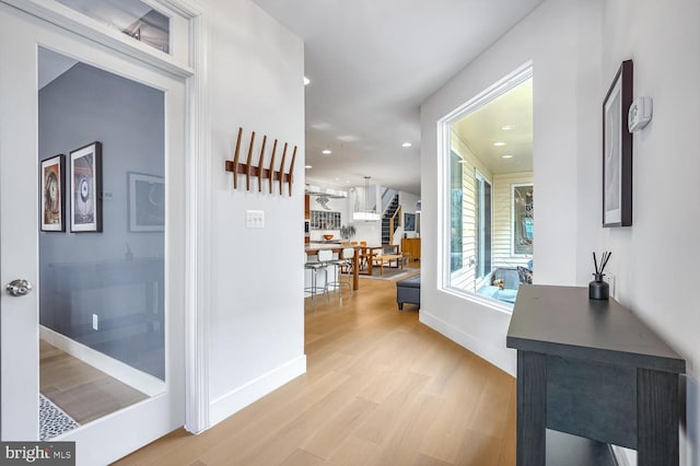 hallway with light hardwood / wood-style flooring