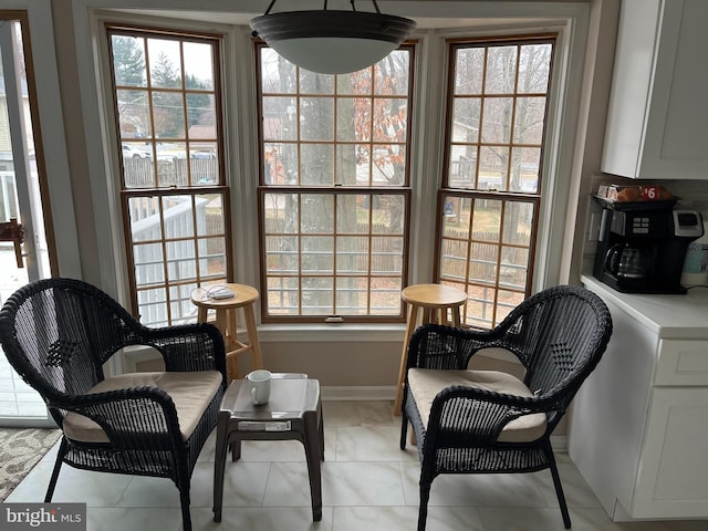 sitting room featuring plenty of natural light and light tile patterned flooring