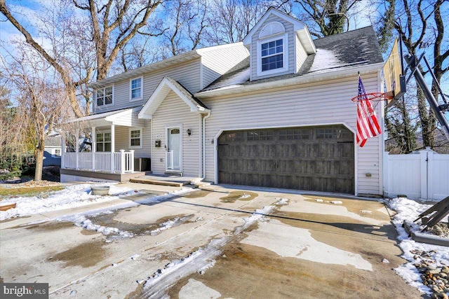 view of front of property with a porch and a garage