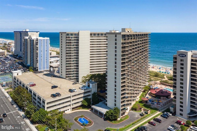 drone / aerial view with a beach view and a water view