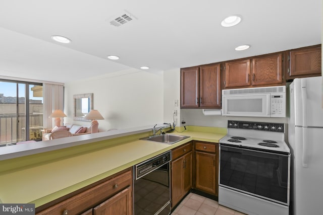 kitchen with light tile patterned flooring, sink, and white appliances