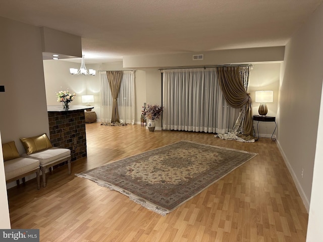 living area featuring hardwood / wood-style flooring and a notable chandelier