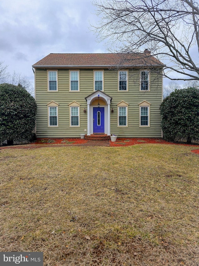 colonial home with a front yard