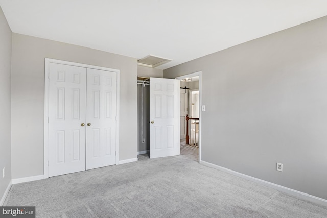 unfurnished bedroom featuring a closet and light colored carpet