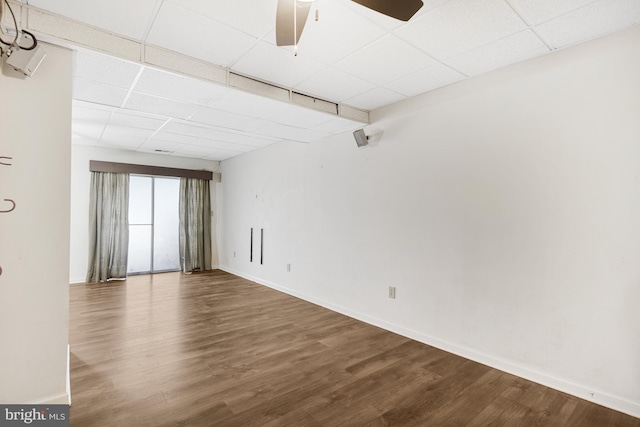 empty room featuring hardwood / wood-style floors, ceiling fan, and a paneled ceiling