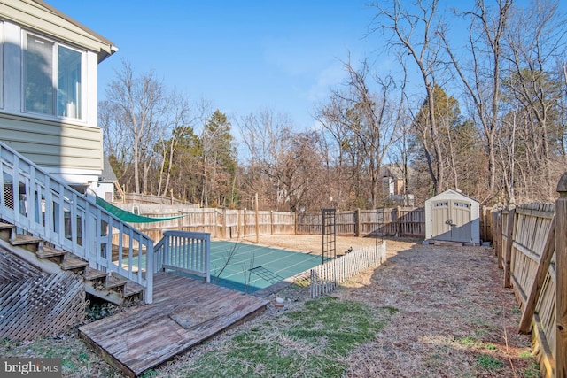 view of yard with a storage shed and a swimming pool side deck