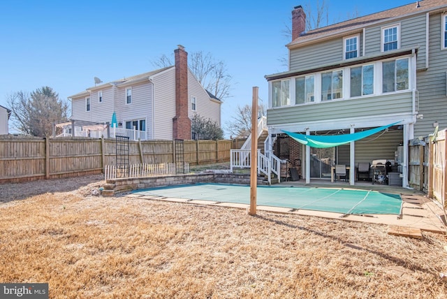 back of property featuring a patio and a sunroom