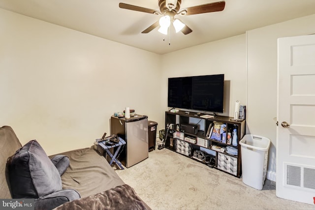 carpeted living room with ceiling fan