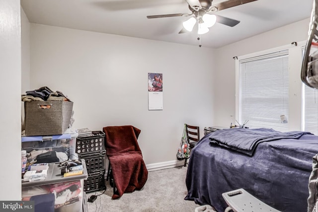 bedroom featuring ceiling fan and light colored carpet