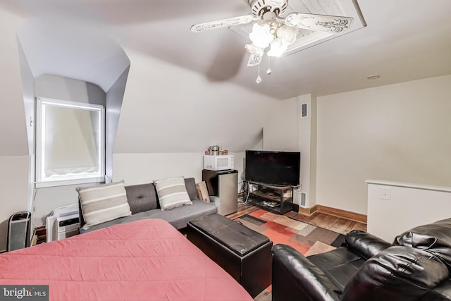 living room featuring vaulted ceiling, wood-type flooring, and ceiling fan