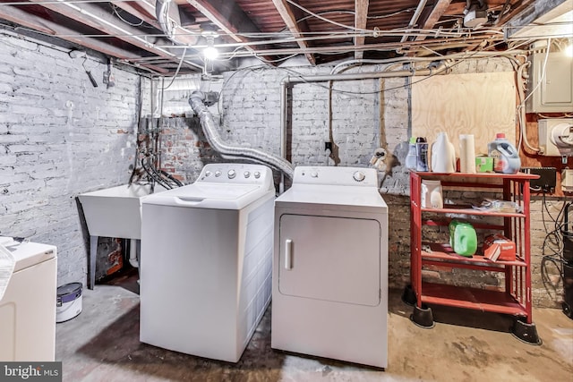 washroom featuring electric panel and washing machine and dryer