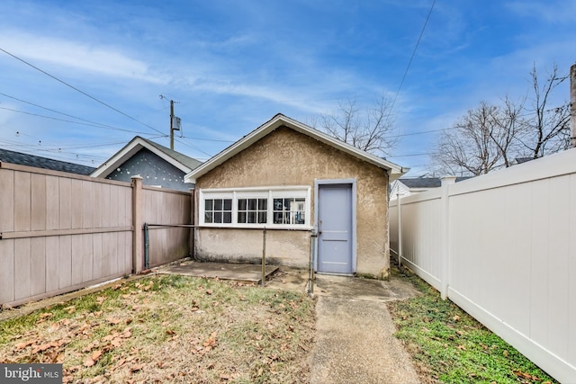 rear view of property with an outbuilding