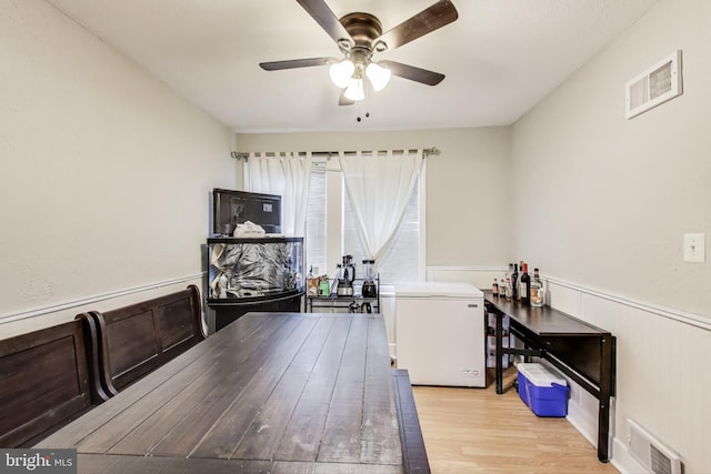 office space featuring ceiling fan and light wood-type flooring