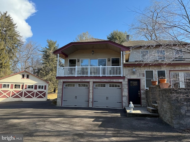 view of front of home featuring a balcony and a garage