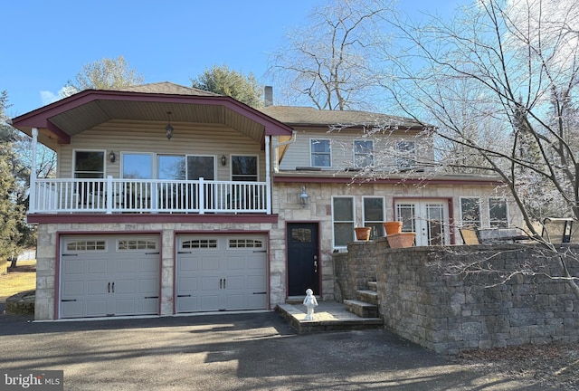 view of front facade with a balcony and a garage