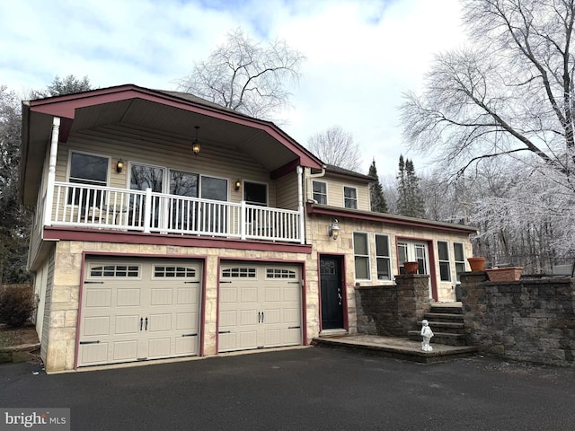 view of front facade with a balcony and a garage