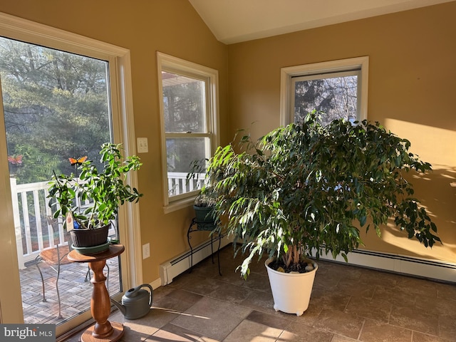 entryway featuring baseboard heating and vaulted ceiling