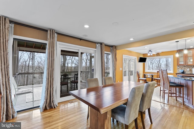 dining room with light wood finished floors, visible vents, and recessed lighting