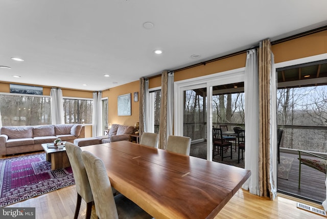 dining space with recessed lighting, light wood-type flooring, and a healthy amount of sunlight