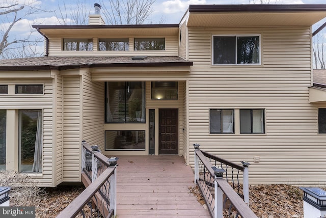 view of front of house with a deck and a chimney