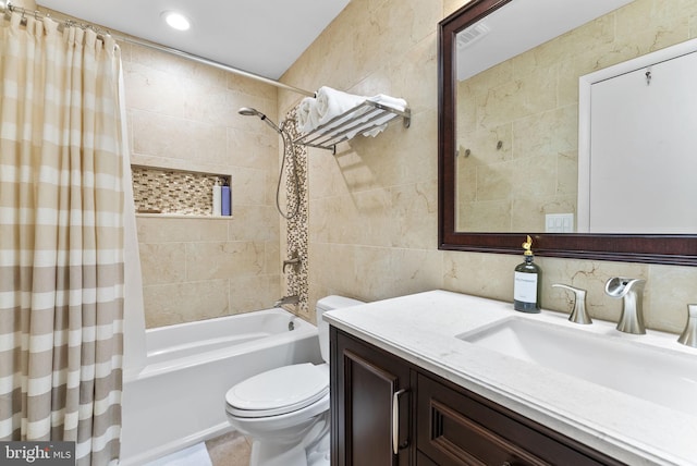 bathroom with toilet, vanity, tile walls, decorative backsplash, and shower / bath combo with shower curtain