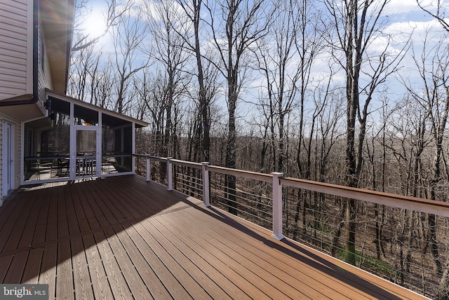 wooden deck featuring a sunroom