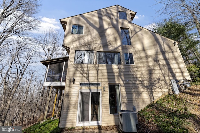 back of house featuring cooling unit and a sunroom