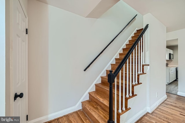 staircase featuring wood-type flooring