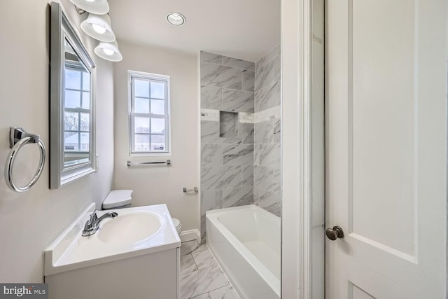 bathroom with vanity and tiled shower / bath combo