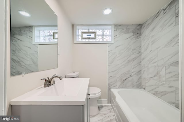 bathroom featuring vanity, a wealth of natural light, and toilet