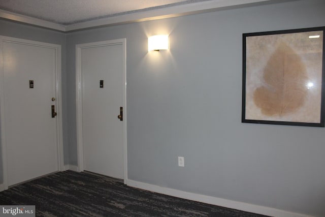 unfurnished room with dark hardwood / wood-style flooring and a textured ceiling