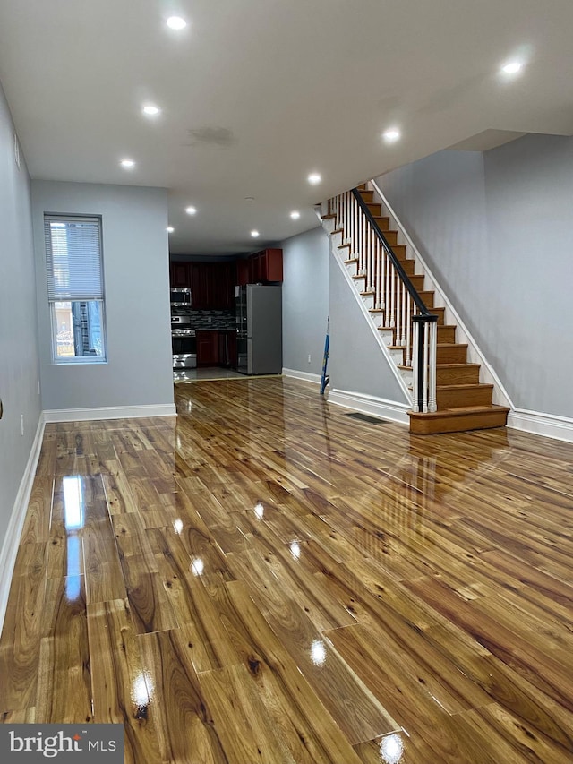 unfurnished living room with dark wood-type flooring