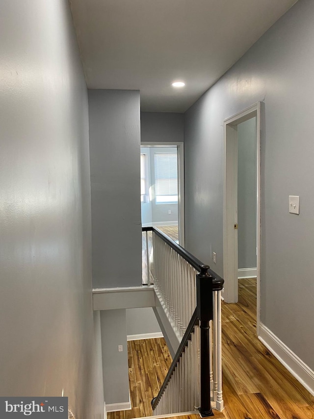 stairs with hardwood / wood-style floors