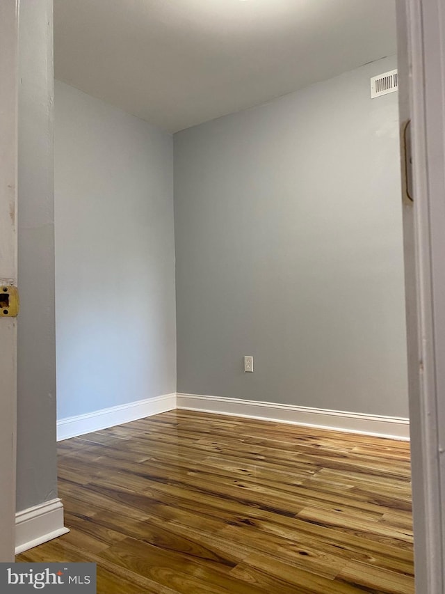 unfurnished room with hardwood / wood-style floors