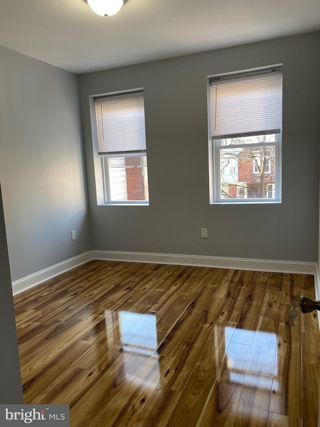 empty room with hardwood / wood-style floors