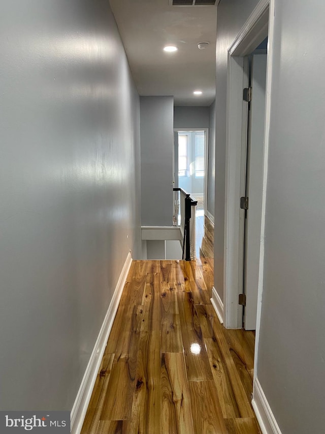 hallway with wood-type flooring