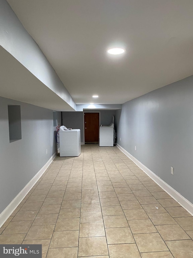 basement with washer / clothes dryer and light tile patterned floors