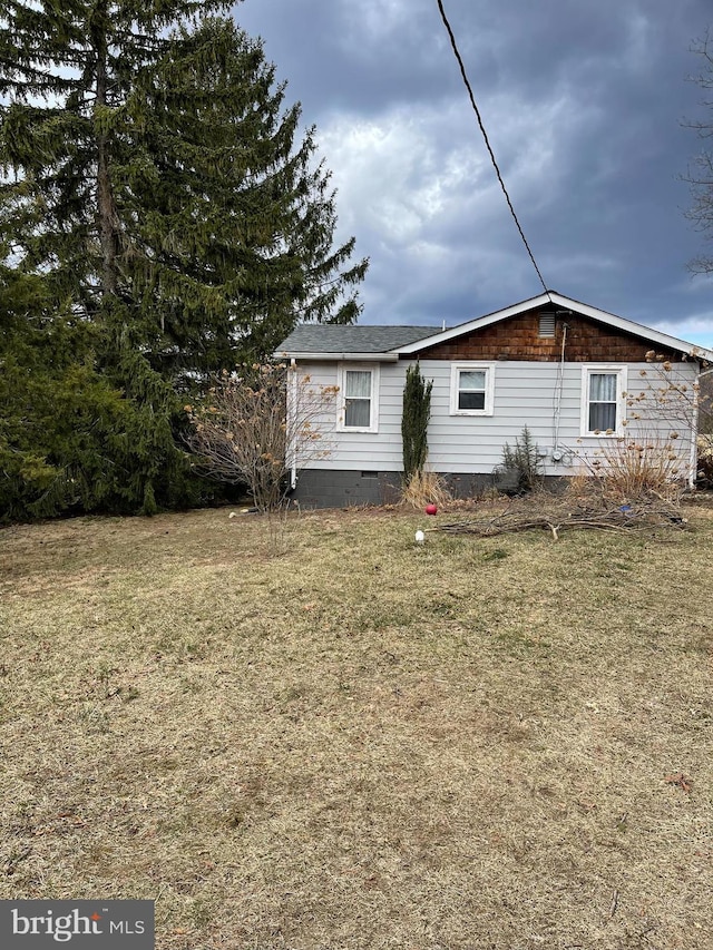 exterior space featuring crawl space and a front lawn