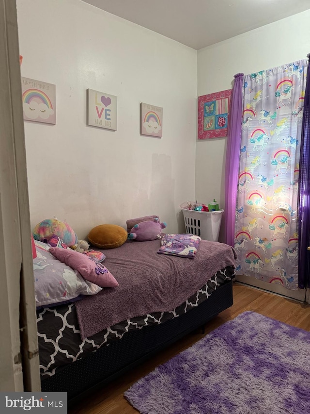 bedroom with hardwood / wood-style flooring