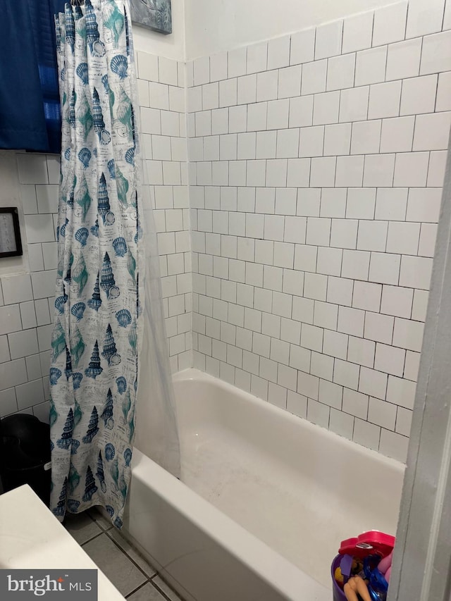 bathroom with tile patterned flooring and shower / bath combo with shower curtain