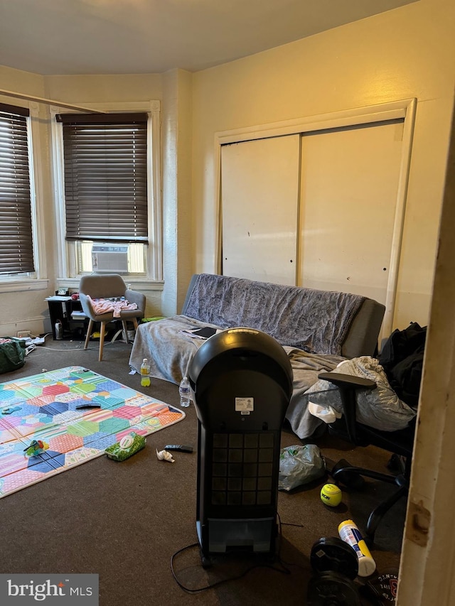 interior space with cooling unit, a closet, and carpet flooring