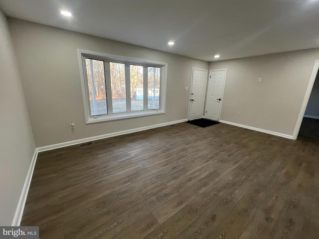 foyer entrance with dark wood-style flooring, recessed lighting, visible vents, and baseboards