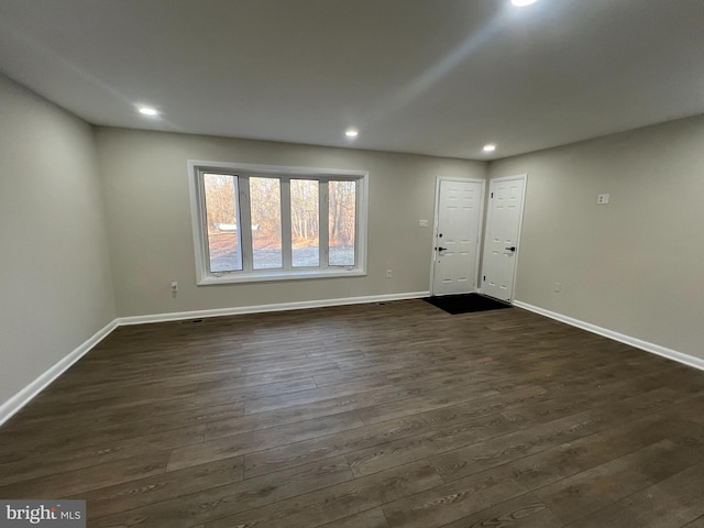 interior space featuring recessed lighting, dark wood finished floors, and baseboards