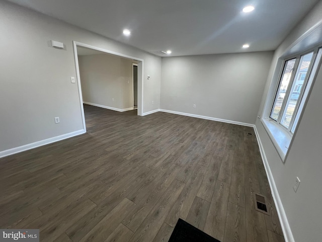 spare room with visible vents, dark wood-type flooring, and recessed lighting