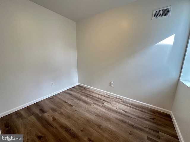 empty room with hardwood / wood-style flooring